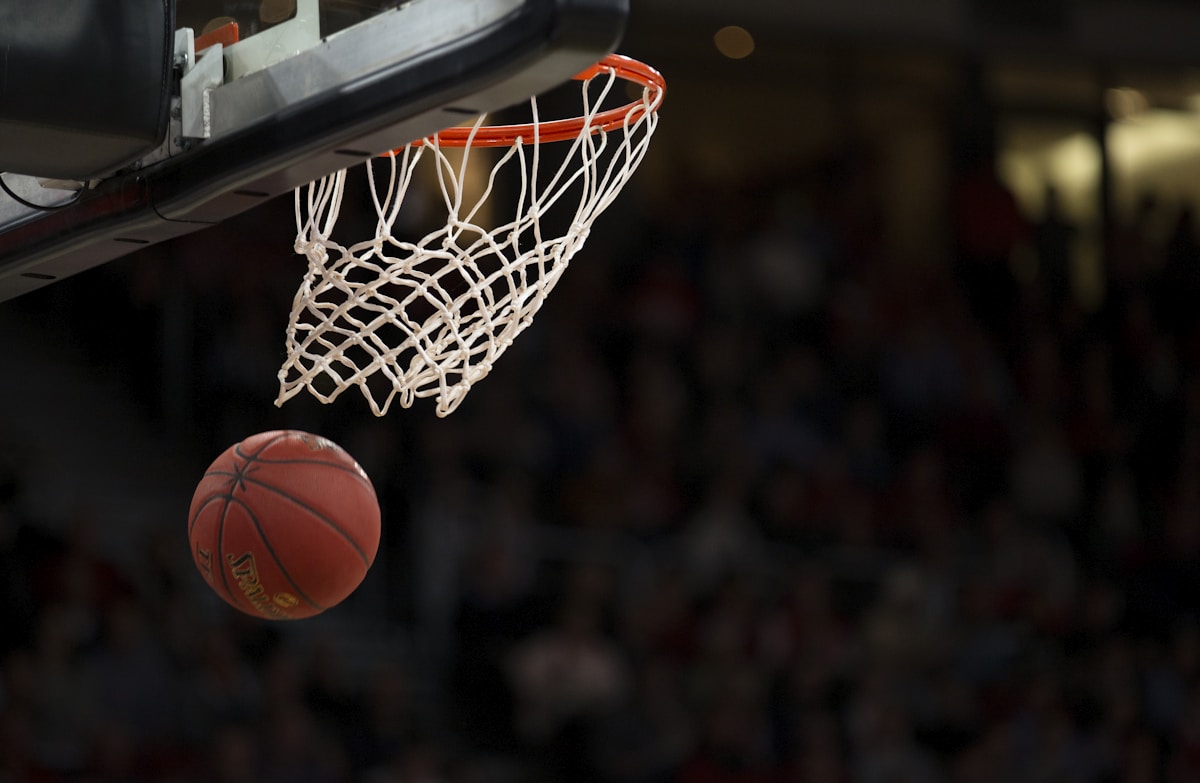 Basketball dropping through the hoop during a game