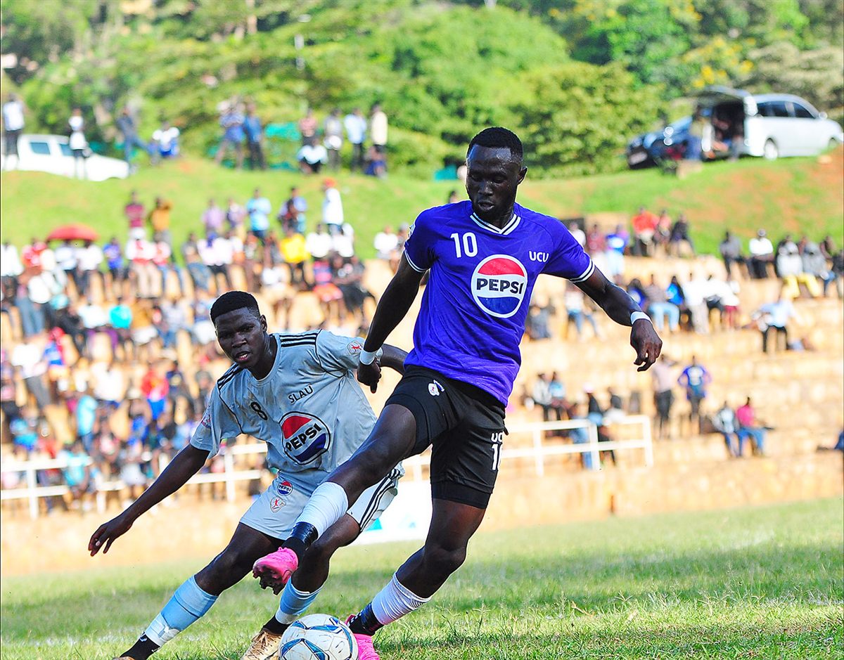 Footballers contest the ball in a league match