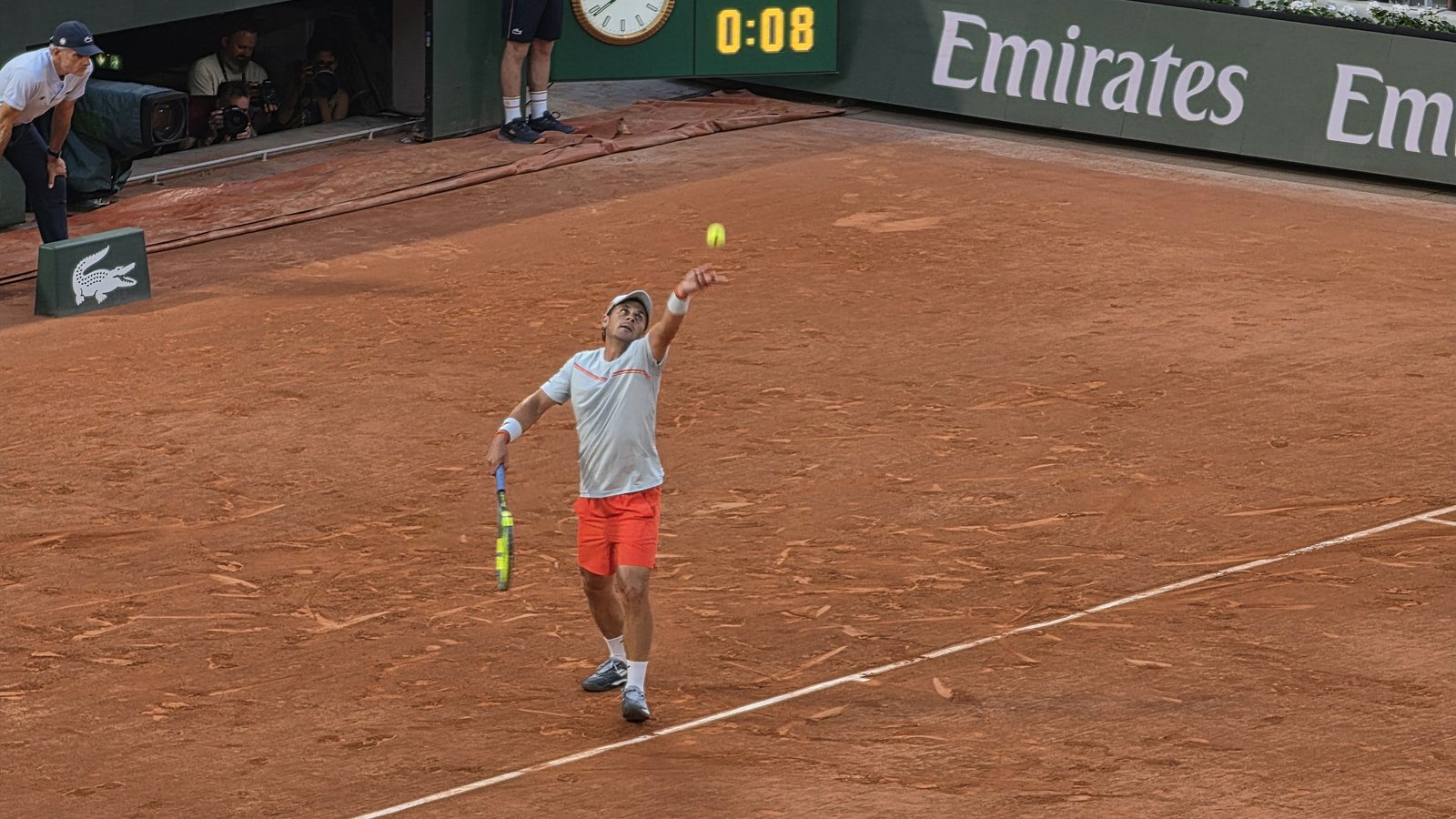 A tennis player hitting a forehand in a match